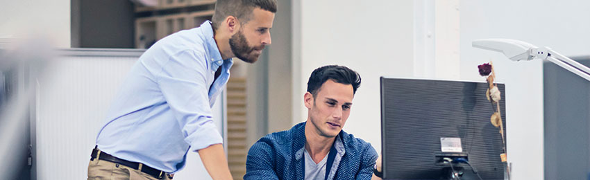 Graphic designers review a design concept on a computer