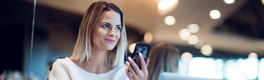 A digital marketer works on her mobile device