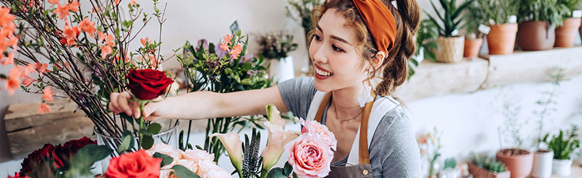 Owner of small floral business arranges flowers