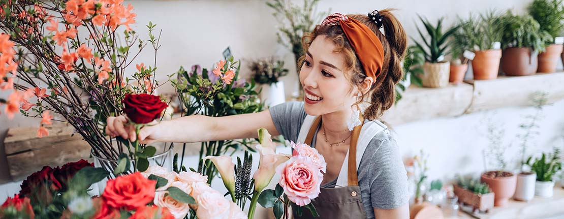 Owner of small floral business arranges flowers