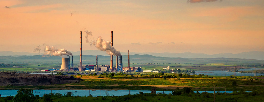 Large structures including smoke stacks in a large field.