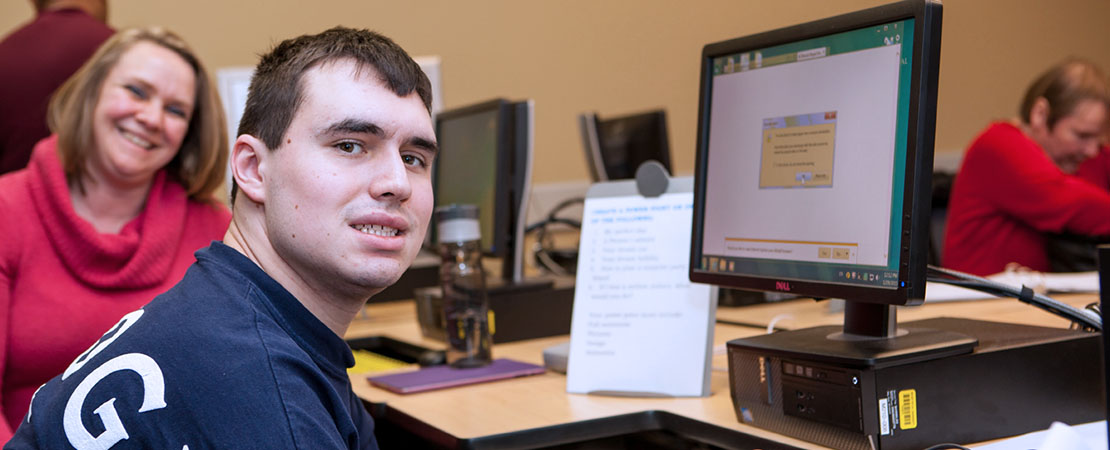 A student attends a computer course with the Transitional Vocational Program.
