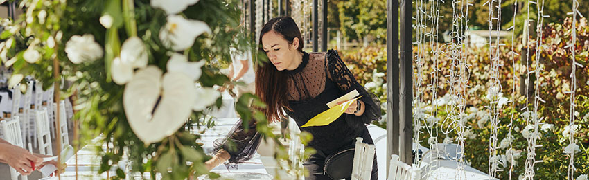 Woman setting up table at large event