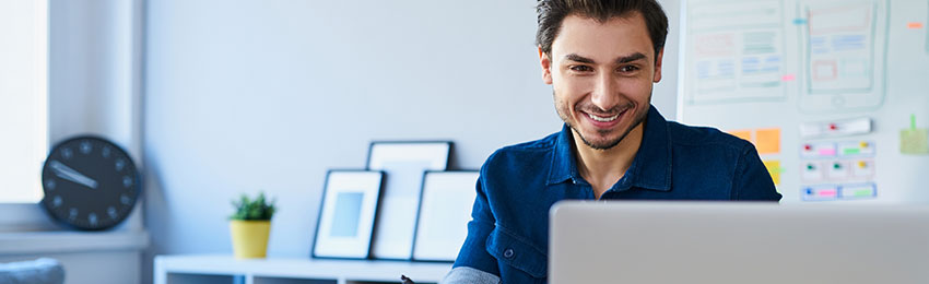 A professional edits documents on his computer 