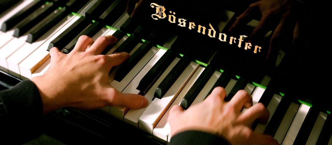 Person playing the piano with two hands
