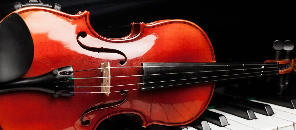 Violin resting on a piano