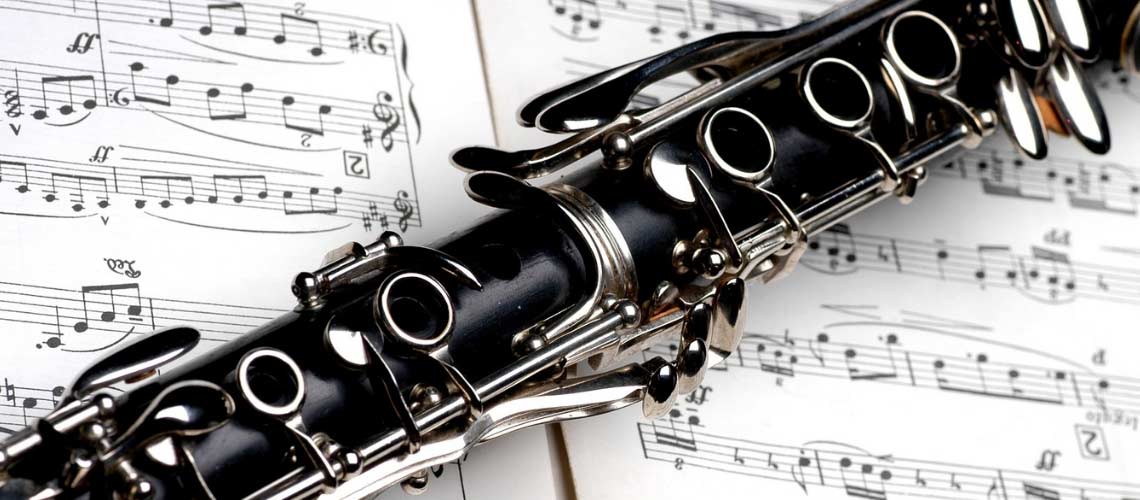 Clarinet resting on top of sheet music