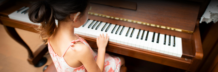 A young pianist at a piano.
